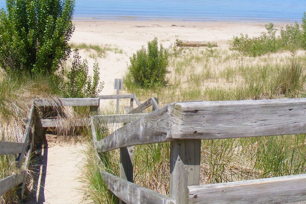 A photo of beach stairs by a shoreline.