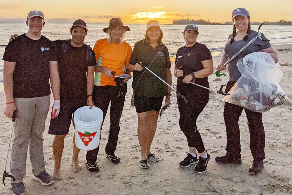 A photo of volunteers helping at sunset beach cleanups.